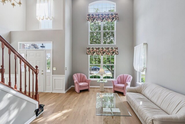 1128 Teasel Ln, Naperville, IL 60564 - living area featuring a towering ceiling, wood finished floors, and stairway