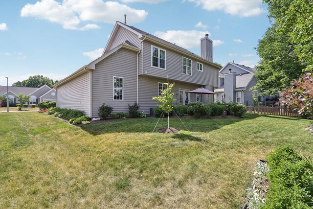 1128 Teasel Ln, Naperville, IL 60564 - rear view of property featuring a chimney