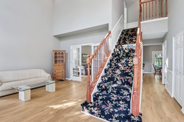 1128 Teasel Ln, Naperville, IL 60564 - staircase featuring a towering ceiling and wood finished floors