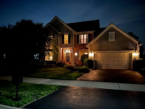 1128 Teasel Ln, Naperville, IL 60564 - traditional home featuring asphalt driveway, a lawn, and an attached garage
