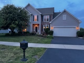 1128 Teasel Ln, Naperville, IL 60564 - traditional-style house with driveway, a front lawn, and a garage