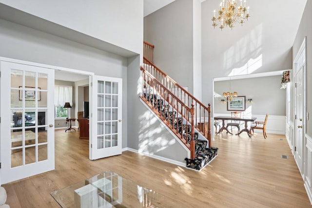 1128 Teasel Ln, Naperville, IL 60564 - entrance foyer with a chandelier, french doors, a towering ceiling, stairway, and wood finished floors