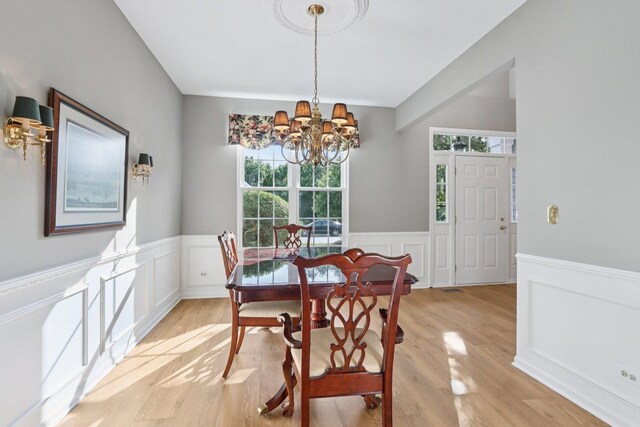 1128 Teasel Ln, Naperville, IL 60564 - dining room with a chandelier, wainscoting, light wood-style floors, and a decorative wall