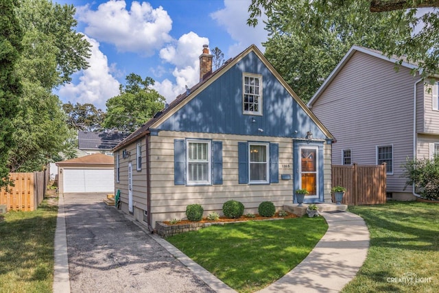 1165 Morton Ave, Elgin, IL 60120 - bungalow featuring a chimney, an outbuilding, and a garage