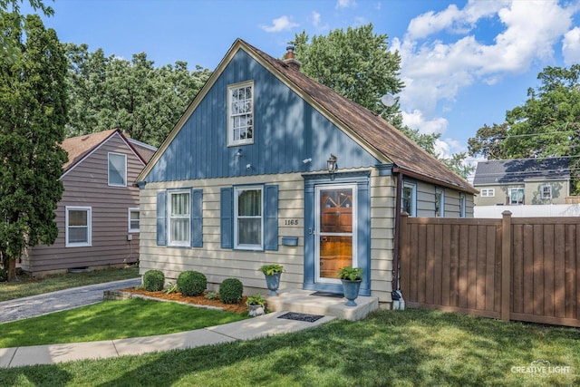 1165 Morton Ave, Elgin, IL 60120 - view of front facade with a chimney and a shingled roof