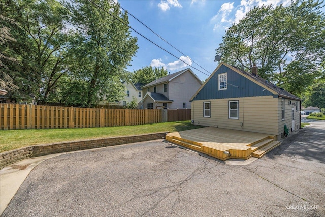 1165 Morton Ave, Elgin, IL 60120 - back of house with a wooden deck, a chimney, and board and batten siding