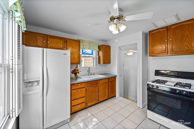 1165 Morton Ave, Elgin, IL 60120 - kitchen with white appliances, ceiling fan, brown cabinetry, and light countertops