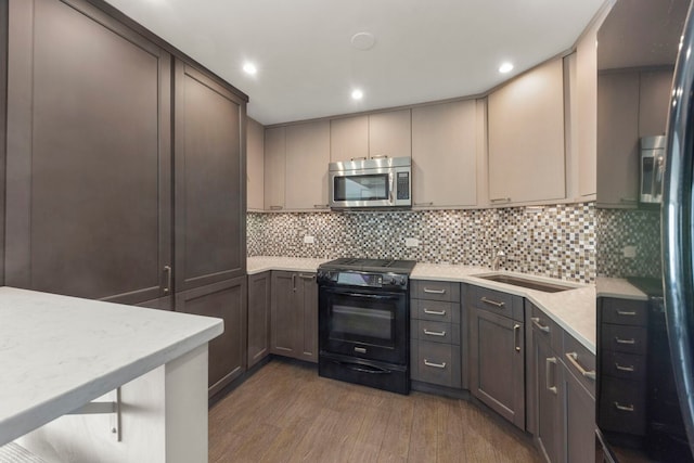 3200 N Lake Shore Dr N Unit 1910, Chicago, IL 60657 - kitchen featuring stainless steel microwave, black range oven, dark wood-style floors, tasteful backsplash, and recessed lighting