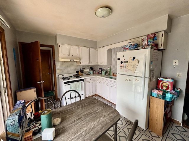1526 Douglas Ct, Belvidere, IL 61008 - kitchen with white appliances, under cabinet range hood, white cabinets, and light countertops