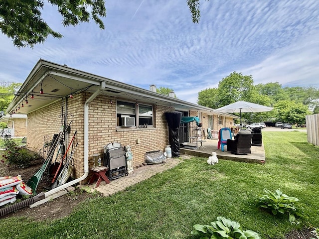 1526 Douglas Ct, Belvidere, IL 61008 - back of house featuring brick siding, a lawn, and a patio area