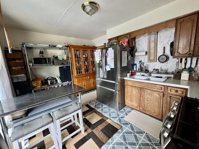 1526 Douglas Ct, Belvidere, IL 61008 - kitchen featuring appliances with stainless steel finishes, light countertops, and brown cabinetry