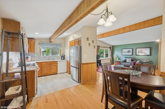 25 W Jeffery Ave, Wheeling, IL 60090 - dining space with wainscoting, light wood-style floors, a chandelier, and vaulted ceiling