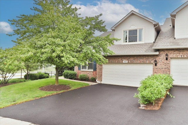 768 W St Johns Pl, Addison, IL 60101 - view of front of property with brick siding, a shingled roof, driveway, a garage, and a front yard