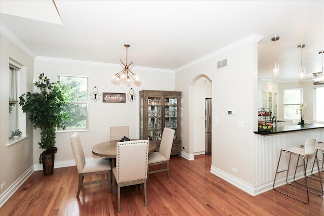 768 W St Johns Pl, Addison, IL 60101 - dining room with wood finished floors, a chandelier, and ornamental molding