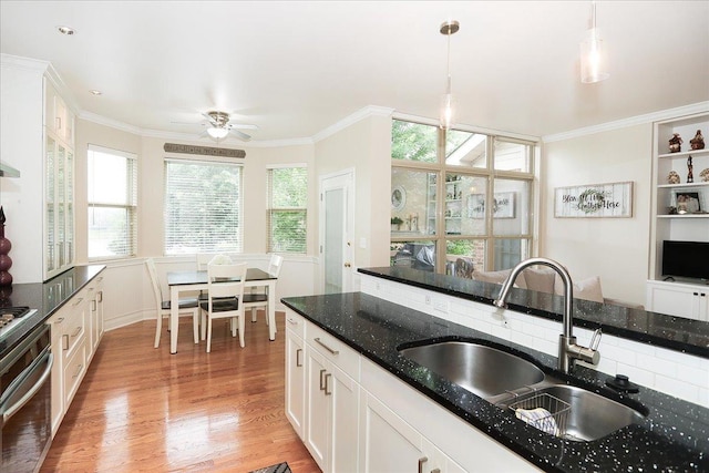 768 W St Johns Pl, Addison, IL 60101 - kitchen with oven, light wood-style floors, white cabinets, ceiling fan, and decorative light fixtures