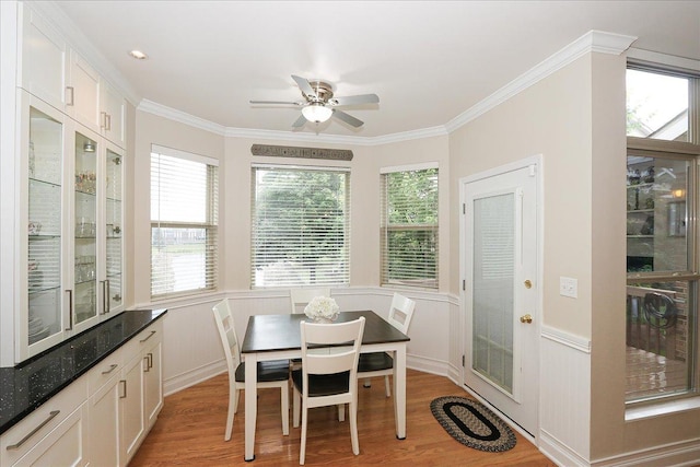 768 W St Johns Pl, Addison, IL 60101 - dining area with light wood-style flooring, plenty of natural light, crown molding, a ceiling fan, and wainscoting