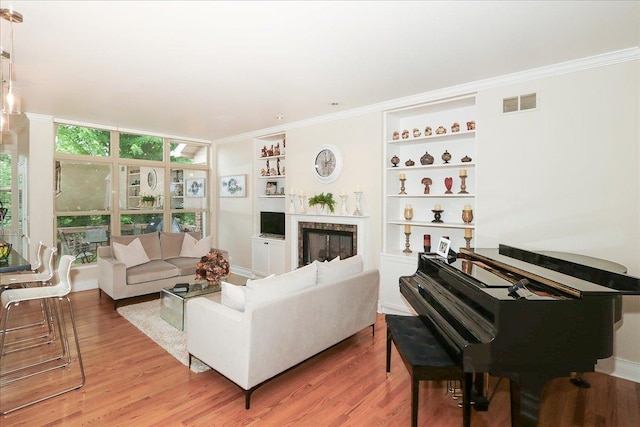 768 W St Johns Pl, Addison, IL 60101 - living area with ornamental molding, light wood-style floors, built in features, and a glass covered fireplace