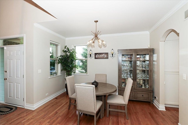 768 W St Johns Pl, Addison, IL 60101 - dining space featuring wood finished floors, arched walkways, crown molding, and a chandelier