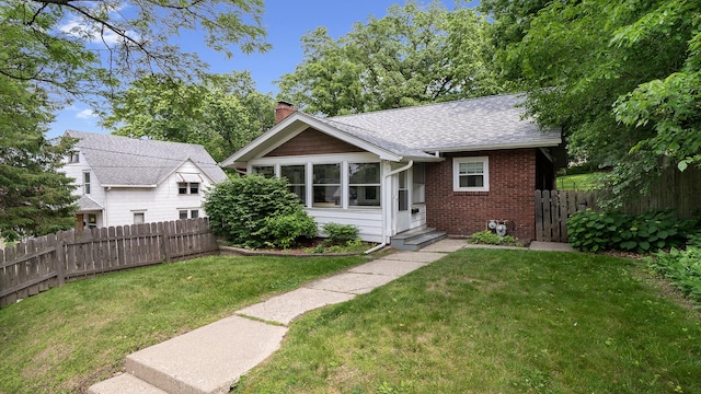931 C St, Rockford, IL 61107 - view of front of house with brick siding, a chimney, a shingled roof, and entry steps