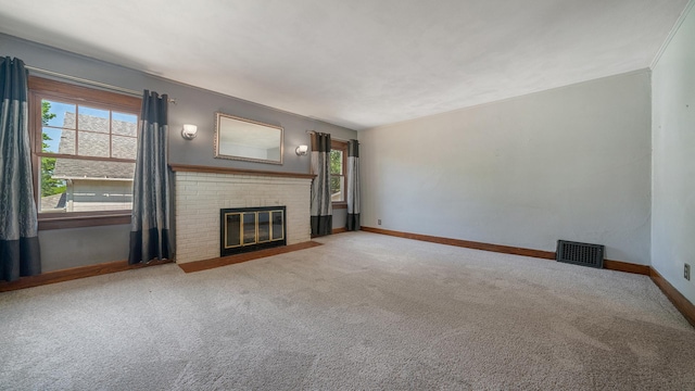 931 C St, Rockford, IL 61107 - unfurnished living room with a brick fireplace and carpet