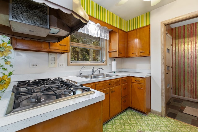14545 Laporte Ave, Midlothian, IL 60445 - kitchen with stainless steel gas cooktop, light flooring, brown cabinets, and light countertops