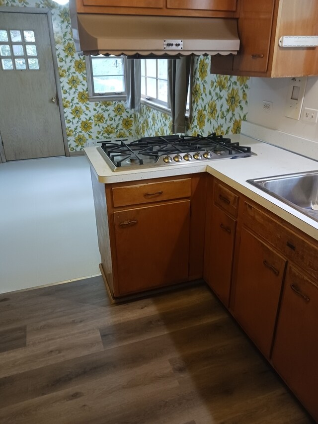 14545 Laporte Ave, Midlothian, IL 60445 - kitchen featuring stainless steel gas stovetop, under cabinet range hood, light countertops, wallpapered walls, and brown cabinets