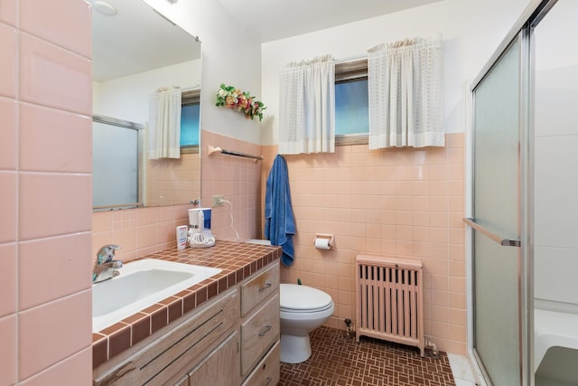 14545 Laporte Ave, Midlothian, IL 60445 - full bathroom featuring radiator, tile walls, a shower with shower door, and vanity