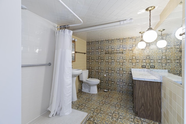 14545 Laporte Ave, Midlothian, IL 60445 - bathroom with tile walls, a tile shower, vanity, and tile patterned floors