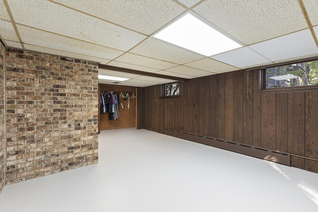 14545 Laporte Ave, Midlothian, IL 60445 - below grade area with a paneled ceiling, a baseboard radiator, wooden walls, and brick wall