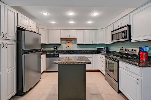 1640 Royal Oak Rd Unit 4, Darien, IL 60561 - kitchen featuring stainless steel appliances, a kitchen island, white cabinets, recessed lighting, and dark stone countertops