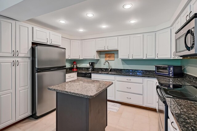 1640 Royal Oak Rd Unit 4, Darien, IL 60561 - kitchen with stainless steel appliances, white cabinetry, dark stone counters, a center island, and recessed lighting