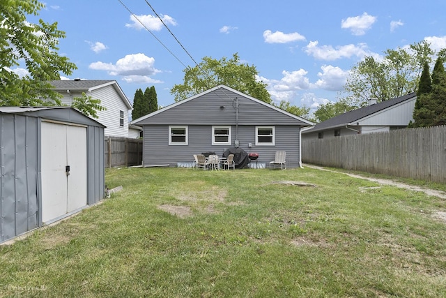 1808 Jethro Ave, Zion, IL 60099 - back of house with a storage unit and a fenced backyard
