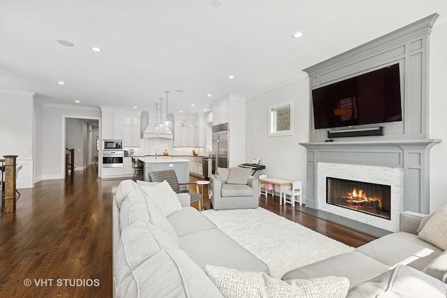 3526 N Hamilton Ave, Chicago, IL 60618 - living room featuring ornamental molding, dark wood-type flooring, a lit fireplace, and recessed lighting