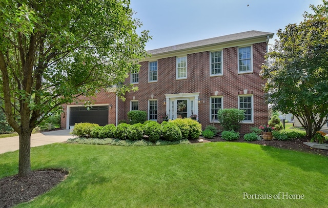 459 Waubonsee Cir, Oswego, IL 60543 - colonial-style house with concrete driveway, a front yard, brick siding, and an attached garage