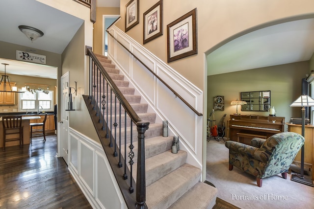 459 Waubonsee Cir, Oswego, IL 60543 - staircase with wood finished floors and arched walkways