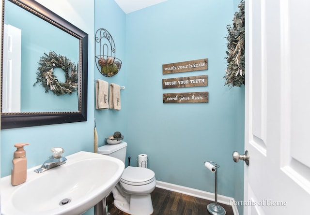 459 Waubonsee Cir, Oswego, IL 60543 - half bath featuring a sink and wood finished floors