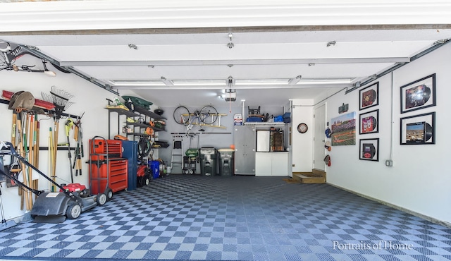 459 Waubonsee Cir, Oswego, IL 60543 - garage featuring a garage door opener and baseboards
