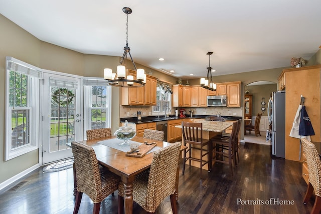 459 Waubonsee Cir, Oswego, IL 60543 - dining area featuring arched walkways, a chandelier, dark wood-type flooring, and recessed lighting