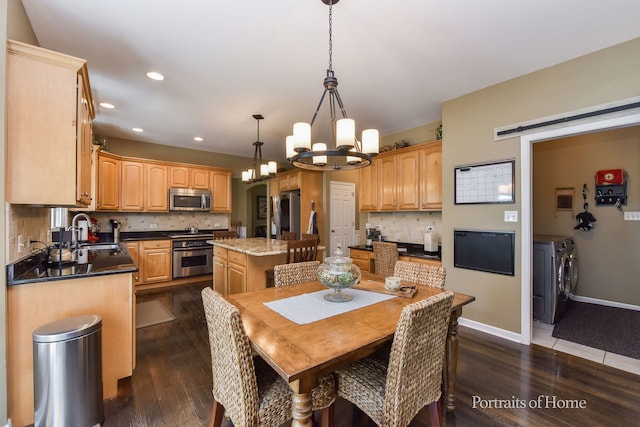 459 Waubonsee Cir, Oswego, IL 60543 - dining space with washer and clothes dryer, a chandelier, dark wood finished floors, recessed lighting, and a barn door
