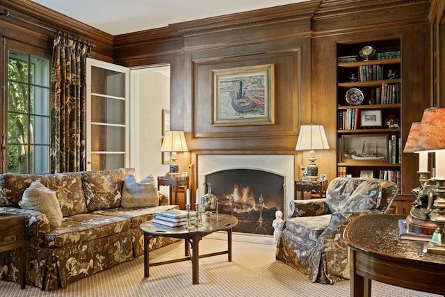 5 Woodley Rd, Winnetka, IL 60093 - living area featuring crown molding, a lit fireplace, carpet floors, wooden walls, and built in shelves