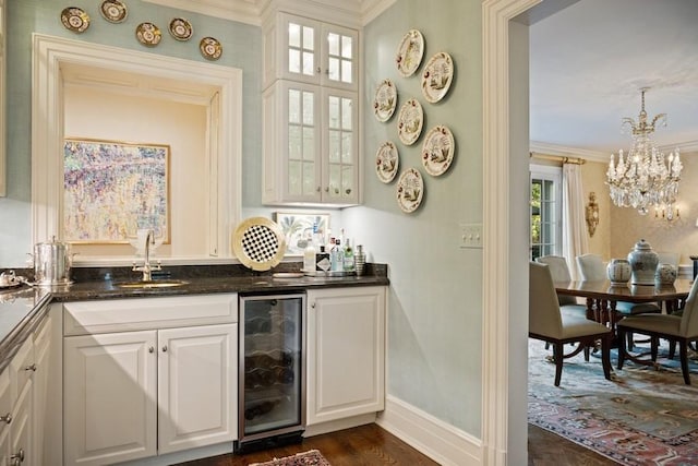 5 Woodley Rd, Winnetka, IL 60093 - indoor wet bar featuring beverage cooler, hanging light fixtures, ornamental molding, a chandelier, and dark wood-type flooring