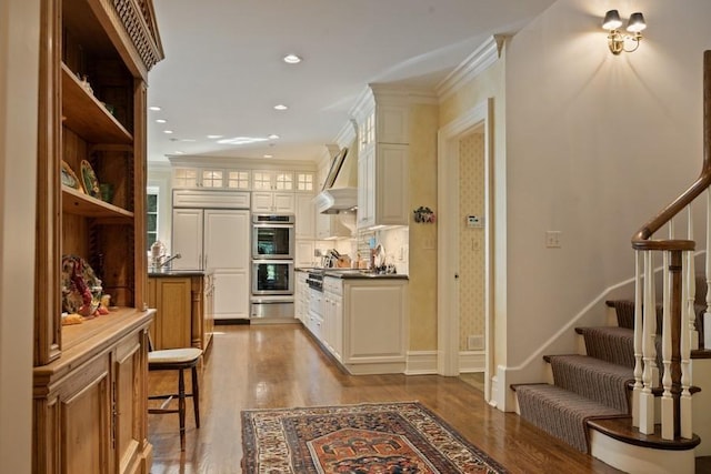 5 Woodley Rd, Winnetka, IL 60093 - hallway featuring wood finished floors, stairs, recessed lighting, and crown molding