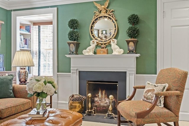 5 Woodley Rd, Winnetka, IL 60093 - sitting room with a decorative wall, ornamental molding, a warm lit fireplace, wainscoting, and carpet floors