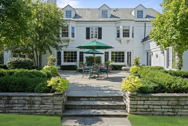 5 Woodley Rd, Winnetka, IL 60093 - rear view of house with a patio and stucco siding