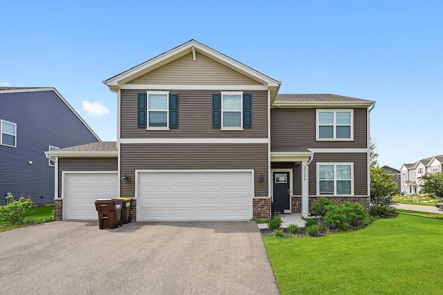 2029 Magnolia Ln, Wonder Lake, IL 60097 - view of front of house with a front lawn, asphalt driveway, and a garage