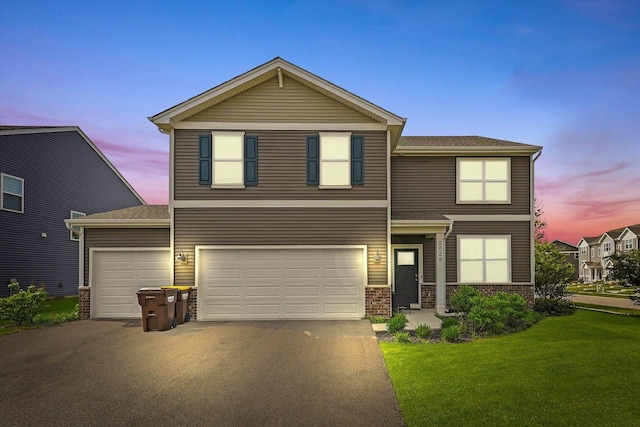 2029 Magnolia Ln, Wonder Lake, IL 60097 - view of front of home with asphalt driveway, a front yard, a garage, and brick siding