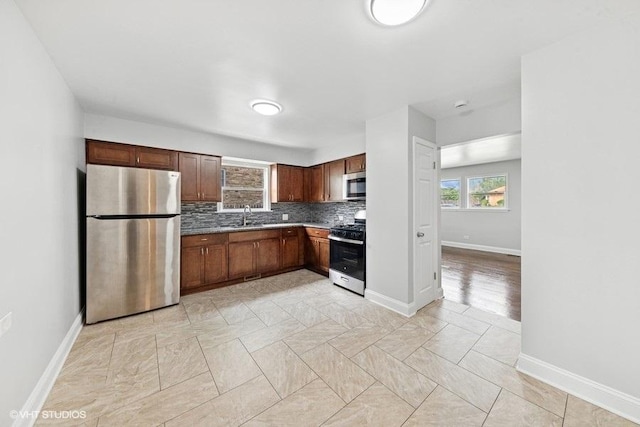 2811 Elim Ave, Zion, IL 60099 - kitchen featuring appliances with stainless steel finishes, tasteful backsplash, and light countertops