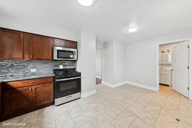 2811 Elim Ave, Zion, IL 60099 - kitchen with stainless steel appliances, tasteful backsplash, and light stone counters