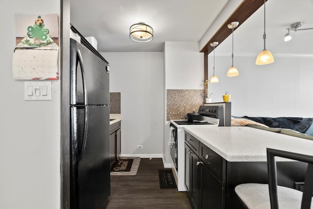 4343 N Clarendon Ave Unit 2309, Chicago, IL 60613 - kitchen featuring range with electric stovetop, light countertops, decorative backsplash, dark wood finished floors, and dark cabinetry