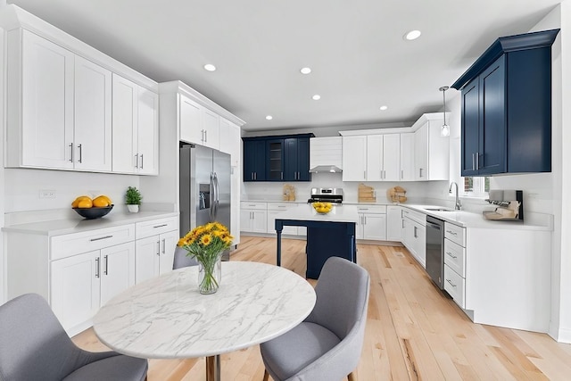6705 W 91st Pl, Oak Lawn, IL 60453 - kitchen featuring stainless steel appliances, recessed lighting, light countertops, wall chimney range hood, and light wood-style floors